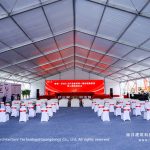 30x40m clear span groundbreaking ceremony tent interior with stage and audience seating for industrial park Phase 2 launch
