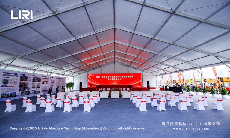30x40m clear span groundbreaking ceremony tent interior with stage and audience seating for industrial park Phase 2 launch