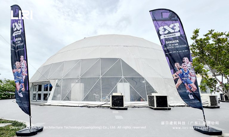 White geodesic dome beside 3x3 W Series Bangkok event flags at Chatuchak
