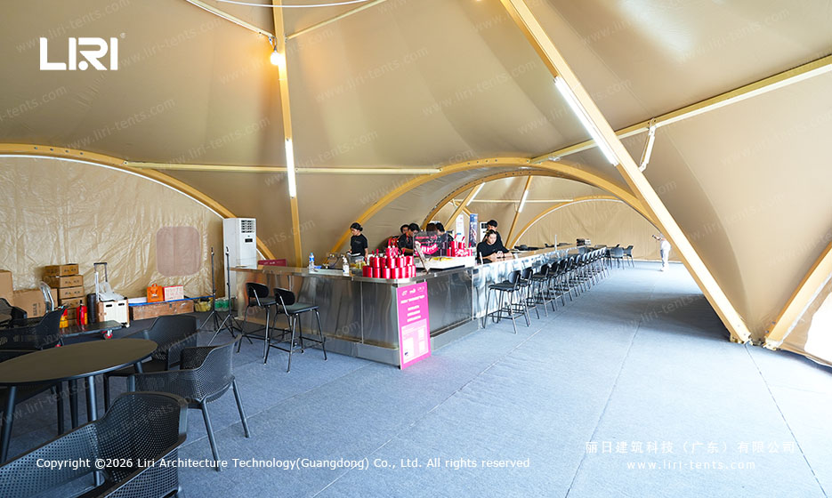 Food service counter and seating inside a connected tented festival space