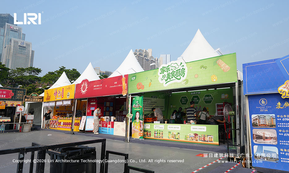 Row of food stalls beneath white peaked event tents at Guangzhou Food Festival