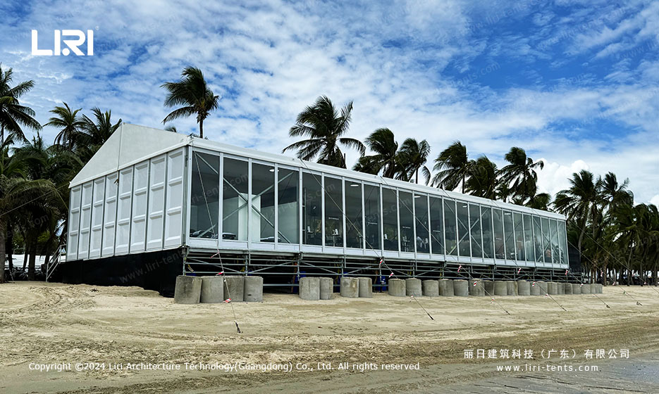 Clear span event tent interior with ocean view through glass wall panels