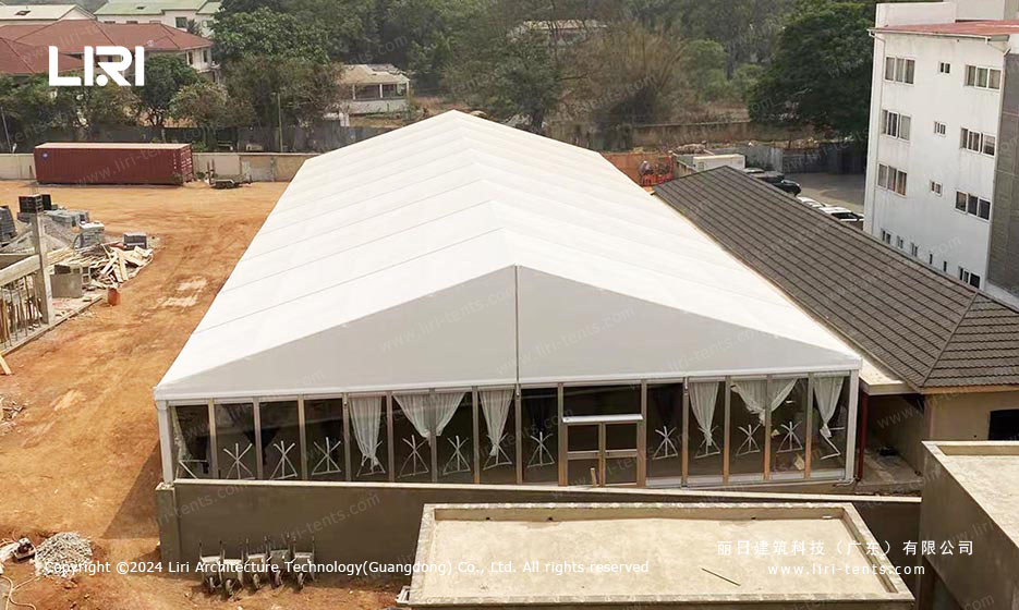 Interior of event tent showing layered curtains and air conditioning unit