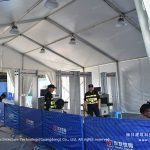 Event tent interior with security checkpoint barriers for staff access control