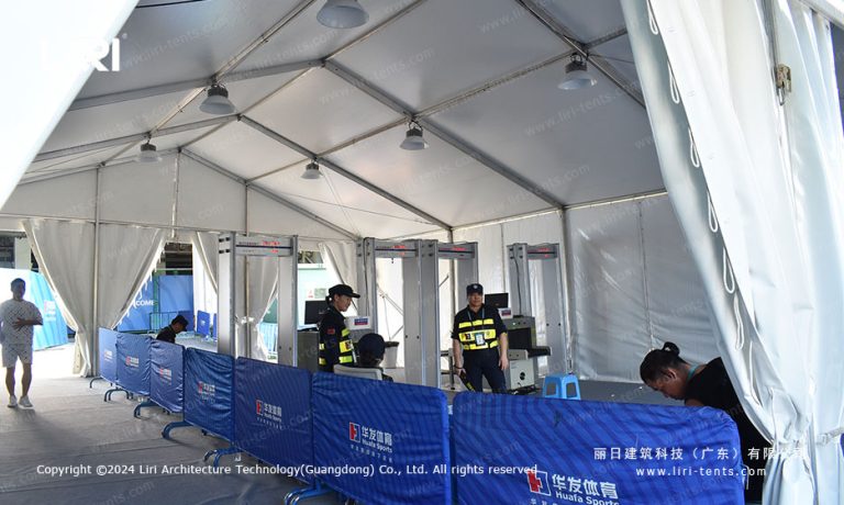 Event tent interior with security checkpoint barriers for staff access control