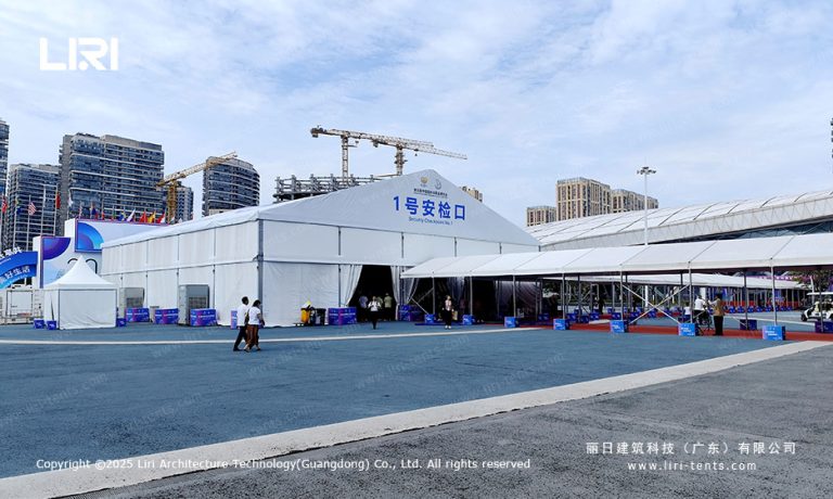 Aerial view of large A-frame security checkpoint tent at a Hainan trade show with international flags