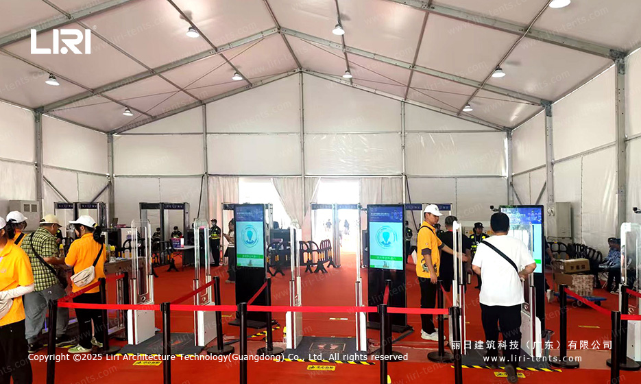 Interior of exhibition tent security checkpoint with face recognition gates and digital signage