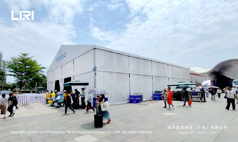 Side rear view of white PVC exhibition tent with solid wall sides at security checkpoint