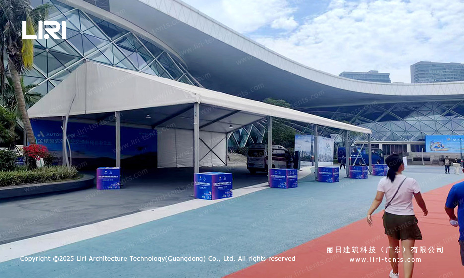 Frame detail of long modular canopy walkway tent between permanent dome building and exhibition