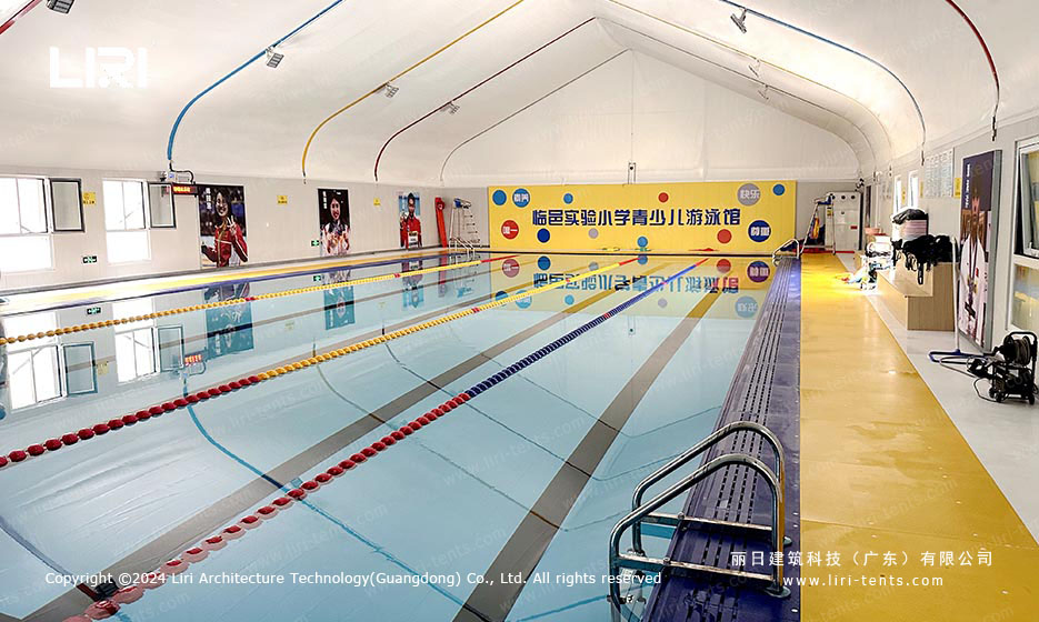 Indoor swimming pool tent with pool lanes and deck