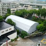 Aerial view of 18.5x36m multi-arch tennis hall tent in urban neighborhood