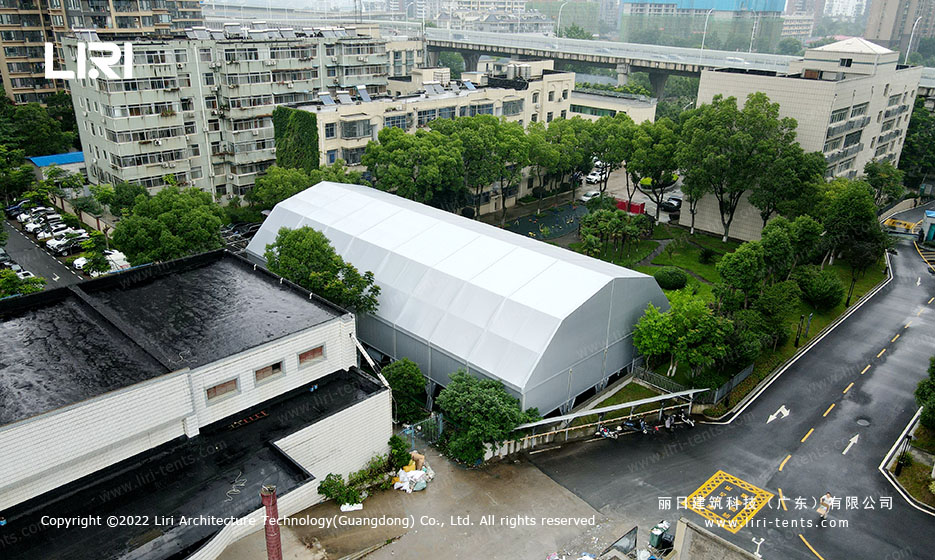 Aerial view of 18.5x36m multi-arch tennis hall tent in urban neighborhood