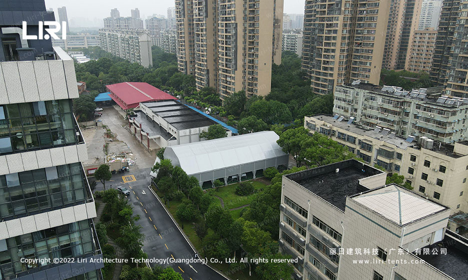 Front aerial view of large multi-arch tennis hall tent 36 meters long