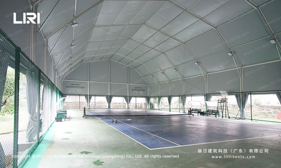 Tennis court inside multi-arch event tent structure