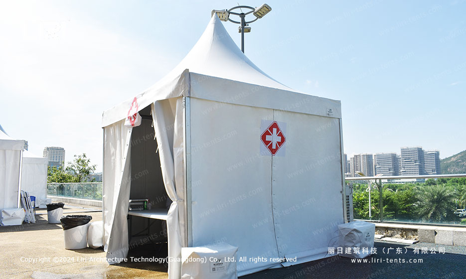 White pagoda tents forming food court row at outdoor tennis festival
