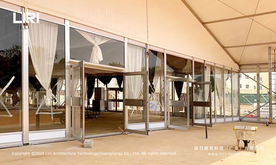 Front entrance of polygon event tent with glass doors at Alisa Hotel