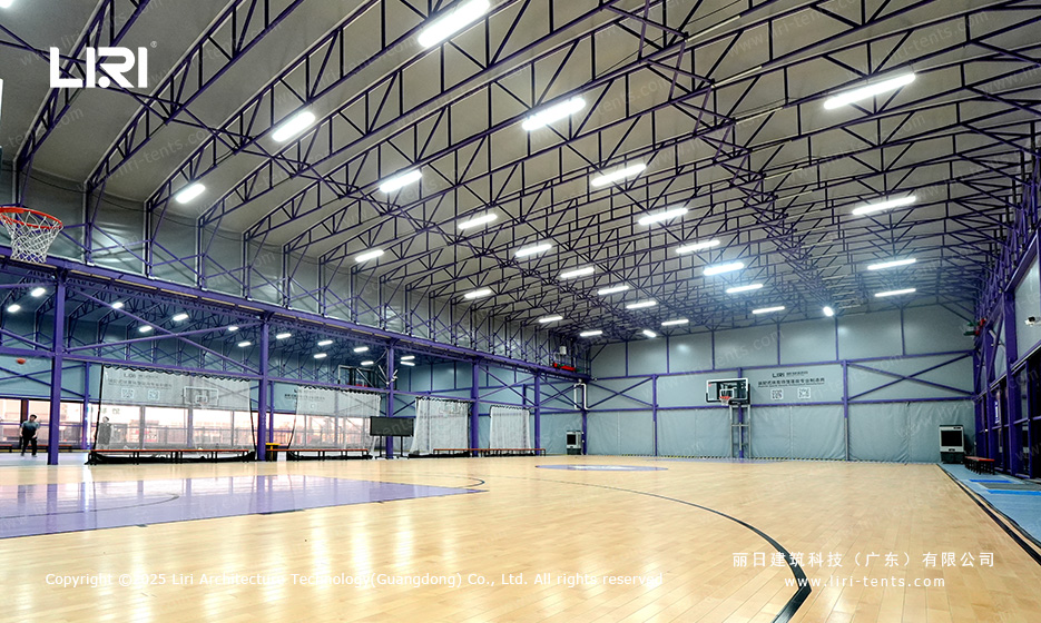 Wide interior view of purple aluminum truss basketball court tent with arched roof and LED lighting