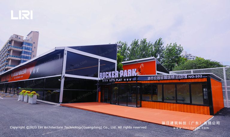 Rucker Park NO.102 badminton hall tent with glass wall and black facade in a city commercial district