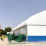 School natatorium tent exterior with white canopy and blue base