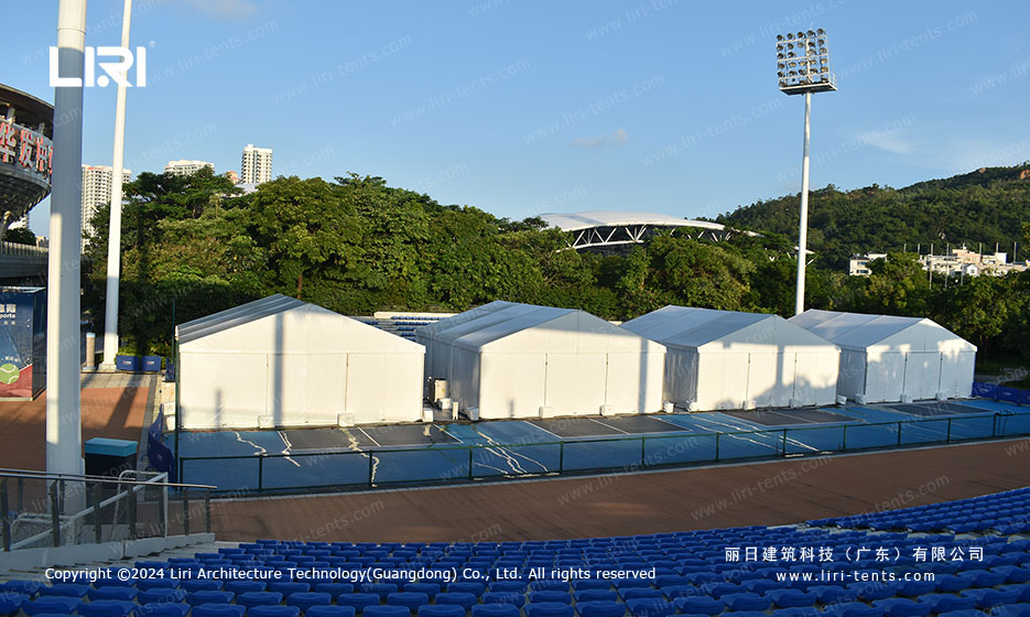 Event tent interior with security checkpoint barriers for staff access control