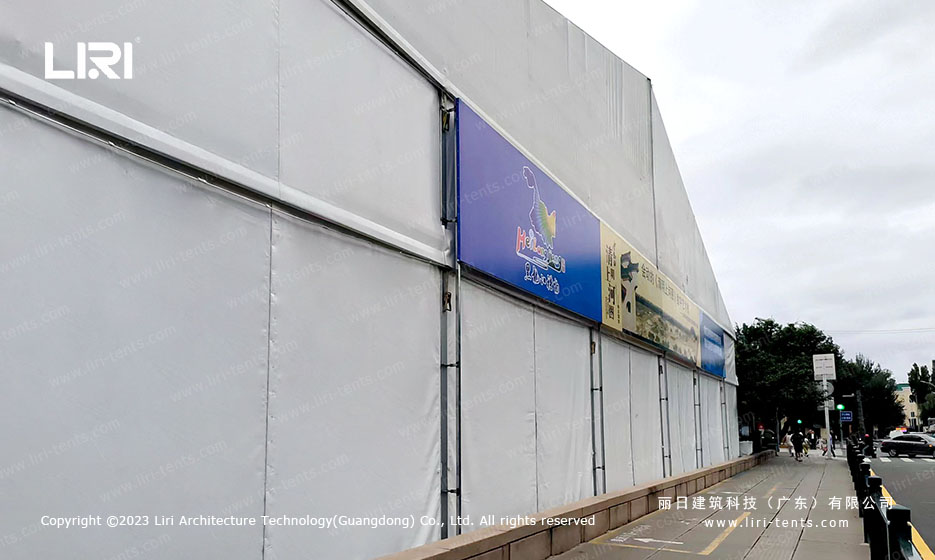 Plaza installation of clear span exhibition tent on paved urban surface without permanent foundation