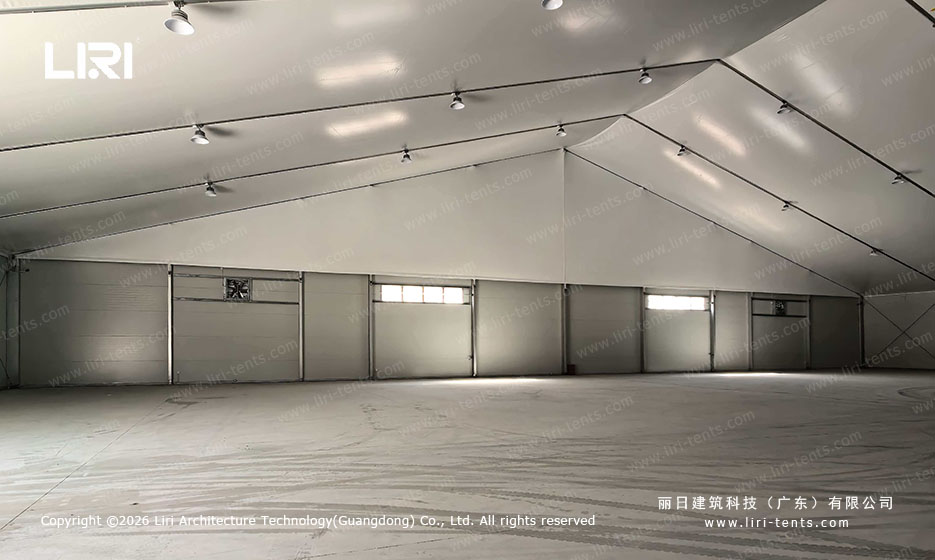 Wide span aircraft hangar interior view showing full length